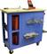 Blue tool trolley with a worktop, equipped with tools and accessories such as drill bits, screwdrivers, and red storage boxes.