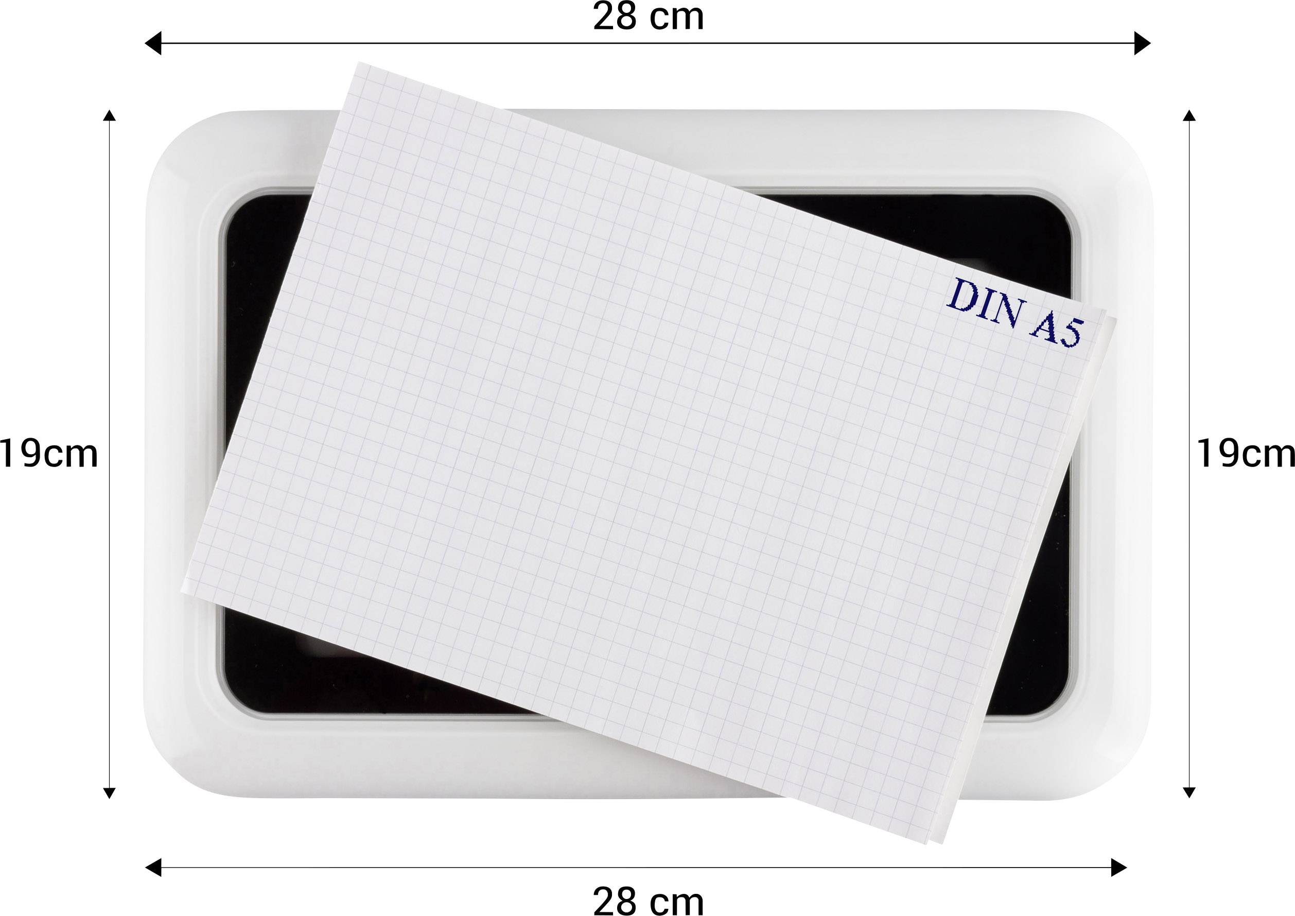 A DIN A5 squared paper lies at an angle on a rectangular tray.