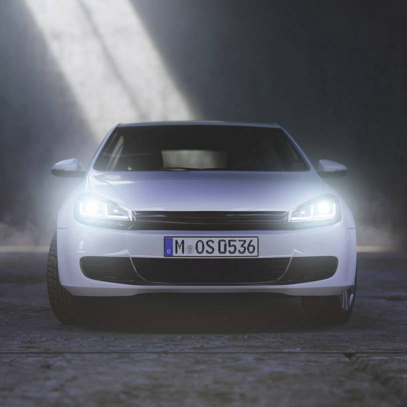 A white car is parked in a dark room, headlights switched on, with a German number plate 'M OS 0536'.