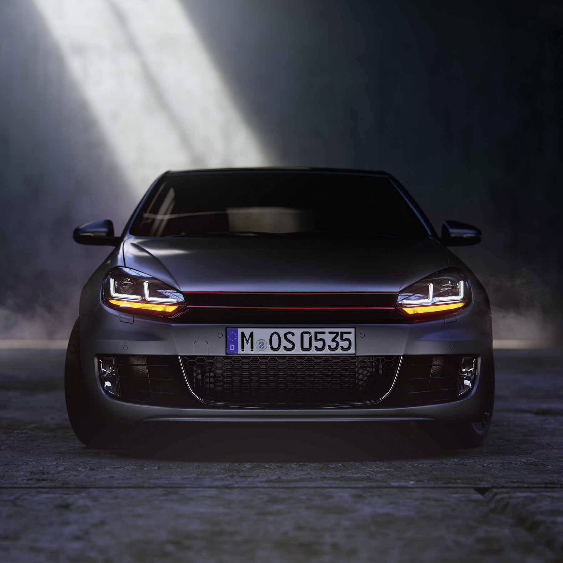 A dark car sits on a car park, illuminated by a single beam of light from above. The number plate is visible.<br><br>Note: In British English, "parking lot" would be translated as "car park", and "license plate" is typically called a "number plate".