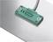 A green sensor with the inscription 'Pepperl+Fuchs', CE marking and 'Made in Germany'. Mounted on a metal surface.