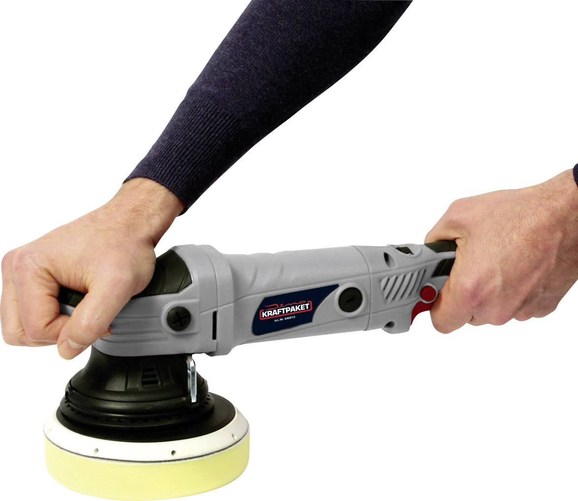 A person is holding an electric polishing machine with two hands. The polishing disc is yellow. The device is grey with a red button.