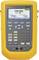 A yellow automatic pressure calibration device with digital display. Shows a pressure reading of '100,000 psi' and temperature '72.22°F'.