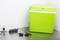 Green portable cool box on kitchen worktop, plugged into a socket. Suitable for camping and travelling.