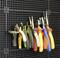 A range of hand tools, including pliers and cutters, are hanging on a black pegboard. They are in various colours.