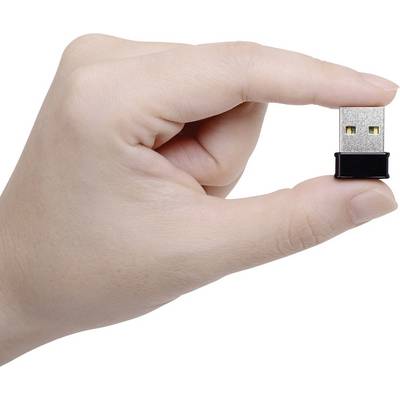 A hand is holding a small USB adapter between the thumb and index finger.