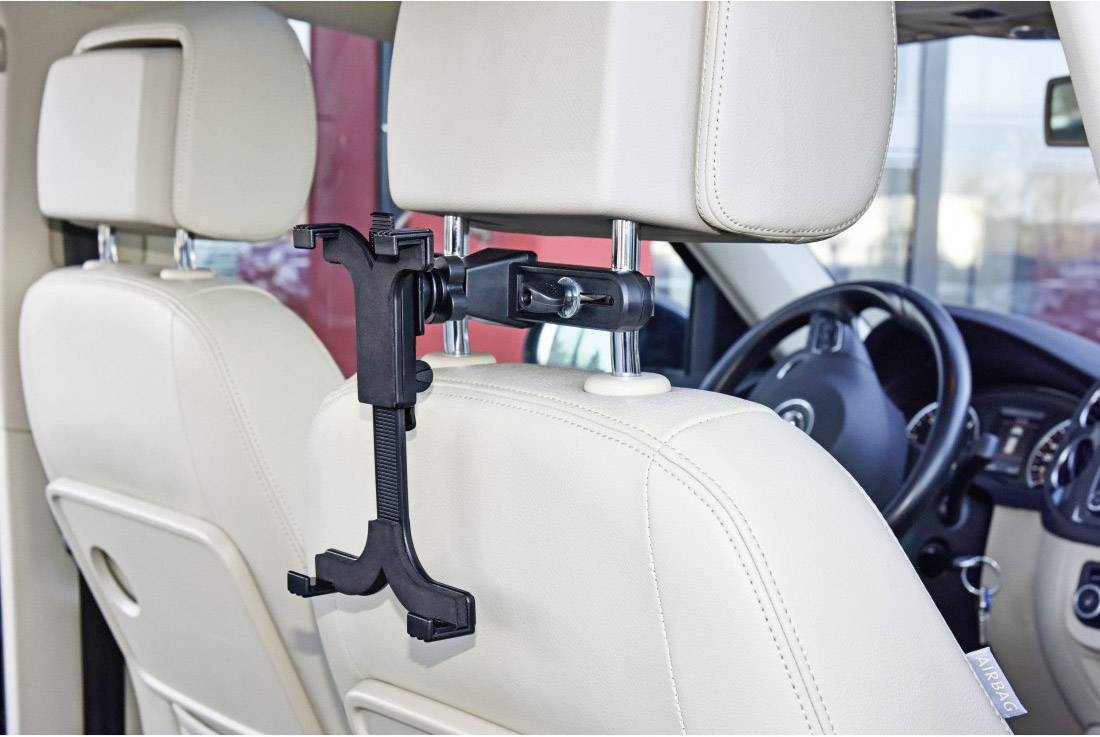 Tablet holder attached to the headrest of a car seat, enabling hands-free tablet use for rear-seat passengers.