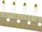 Capacitors mounted on paper strips in series, pointing head upwards, yellow casings with approximately '1/05' printed marking.
