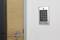 Door with electronic numeric lock on the wall; enables access control through PIN code entry on a numeric keypad.