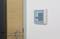 A door with an access control panel featuring a numerical keypad on the wall.