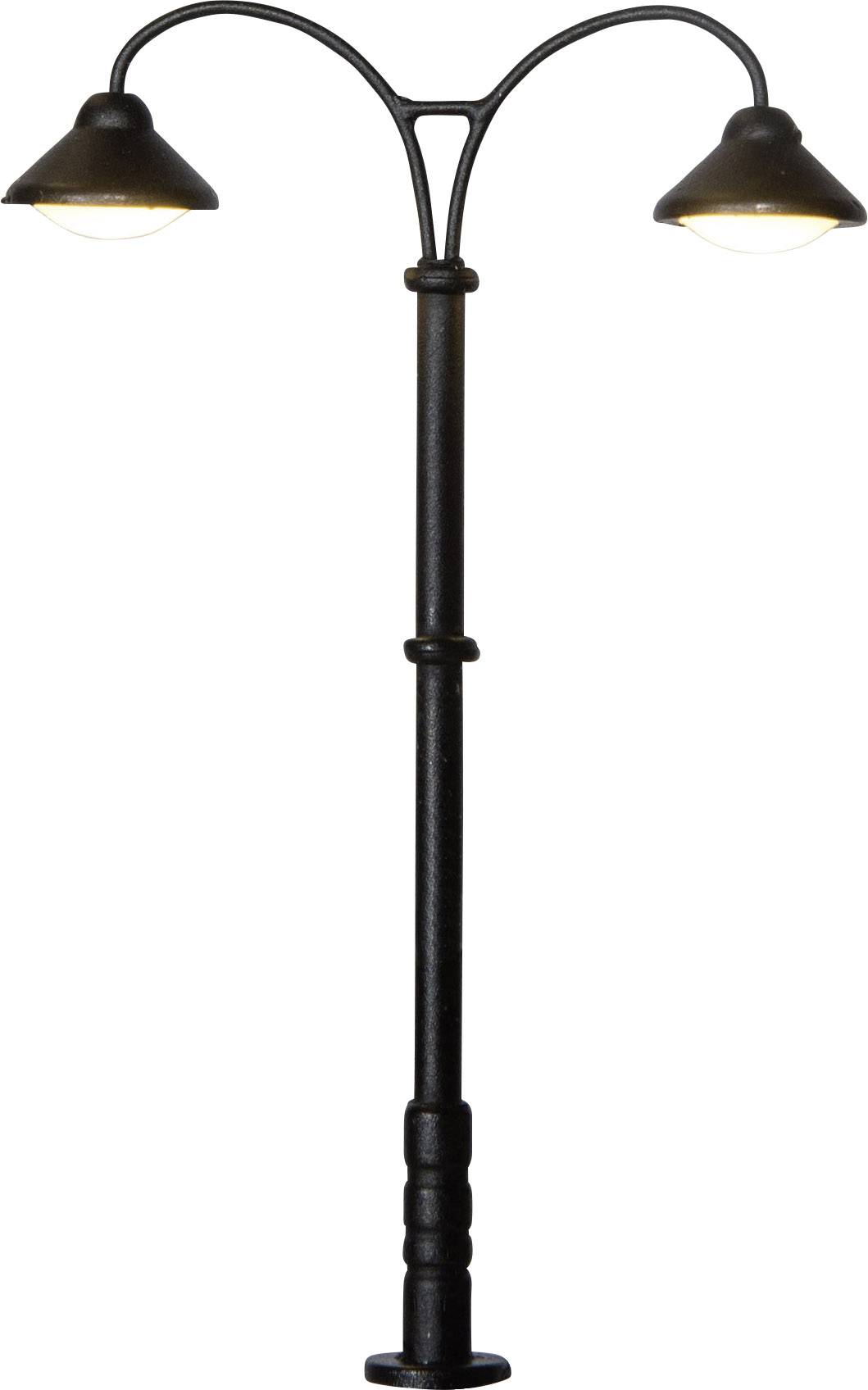 A black double street lamp with two illuminating lights facing opposite directions on a metal pole.