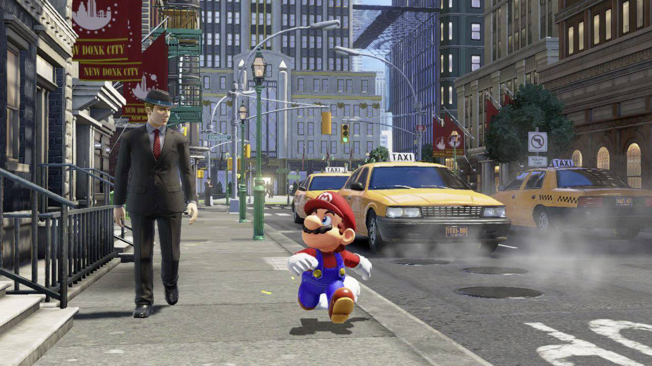 Mario is walking along a pavement in a bustling city with taxis. A man in a suit and hat is walking beside him. Skyscrapers are in the background.