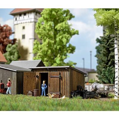 A miniature scene depicts a rural barn with figures and animals in the foreground. A tall tower stands in the background.