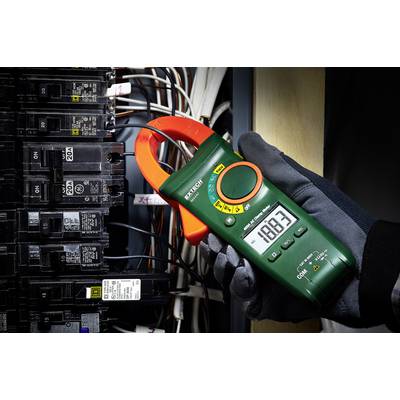A person is holding a digital ammeter while wearing a glove. It is measuring the electrical circuit at 188.3 amperes. Fuses are visible in the background.