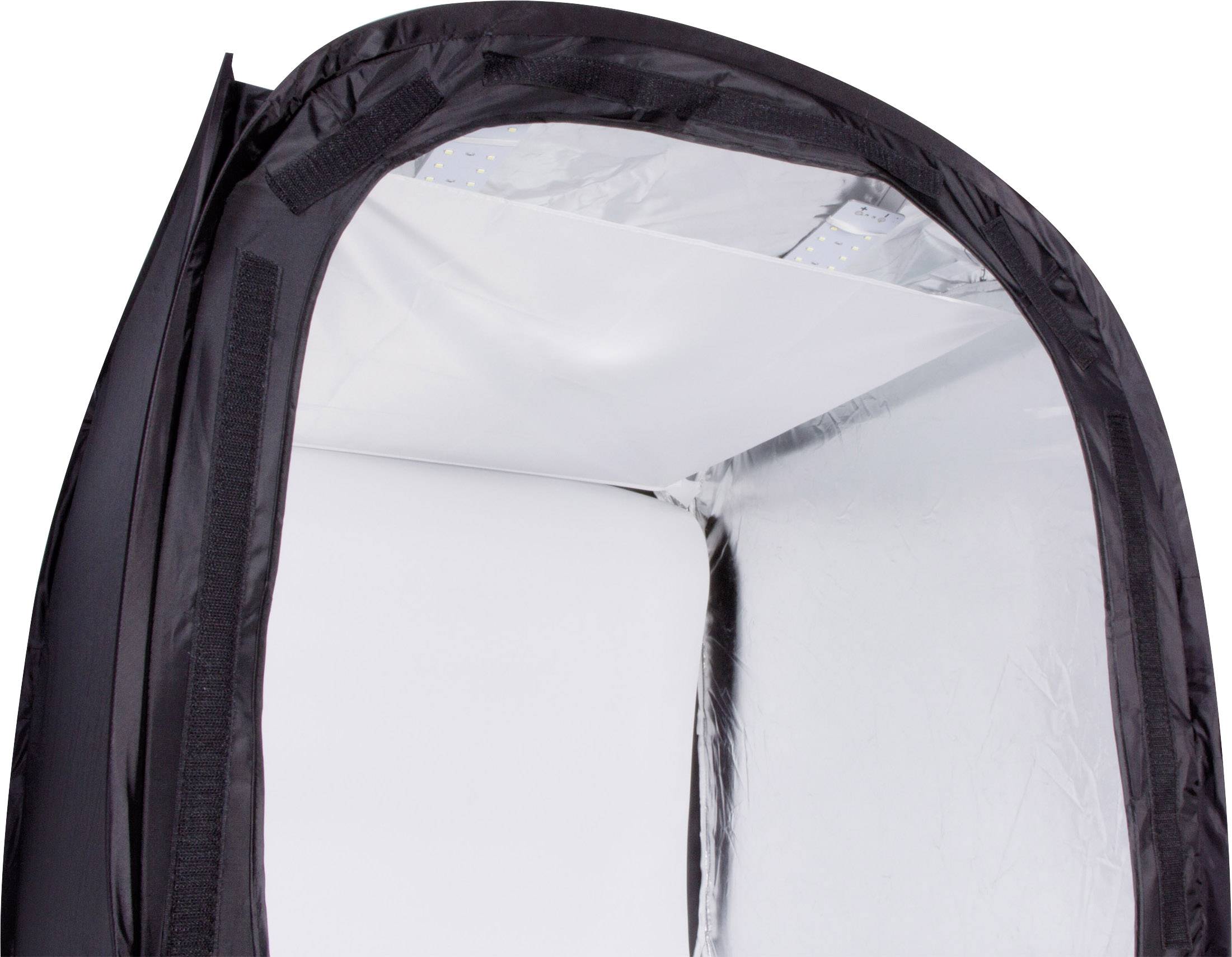 Black, foldable light tent with silver interior, used for uniform illumination in photography.