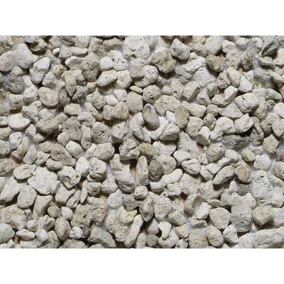 A close-up of small, irregularly shaped, light brown and grey stones, closely arranged and lying flat.