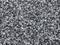 Close-up of a stony asphalt surface with irregular grey and black granulations. The texture appears coarse and rough.