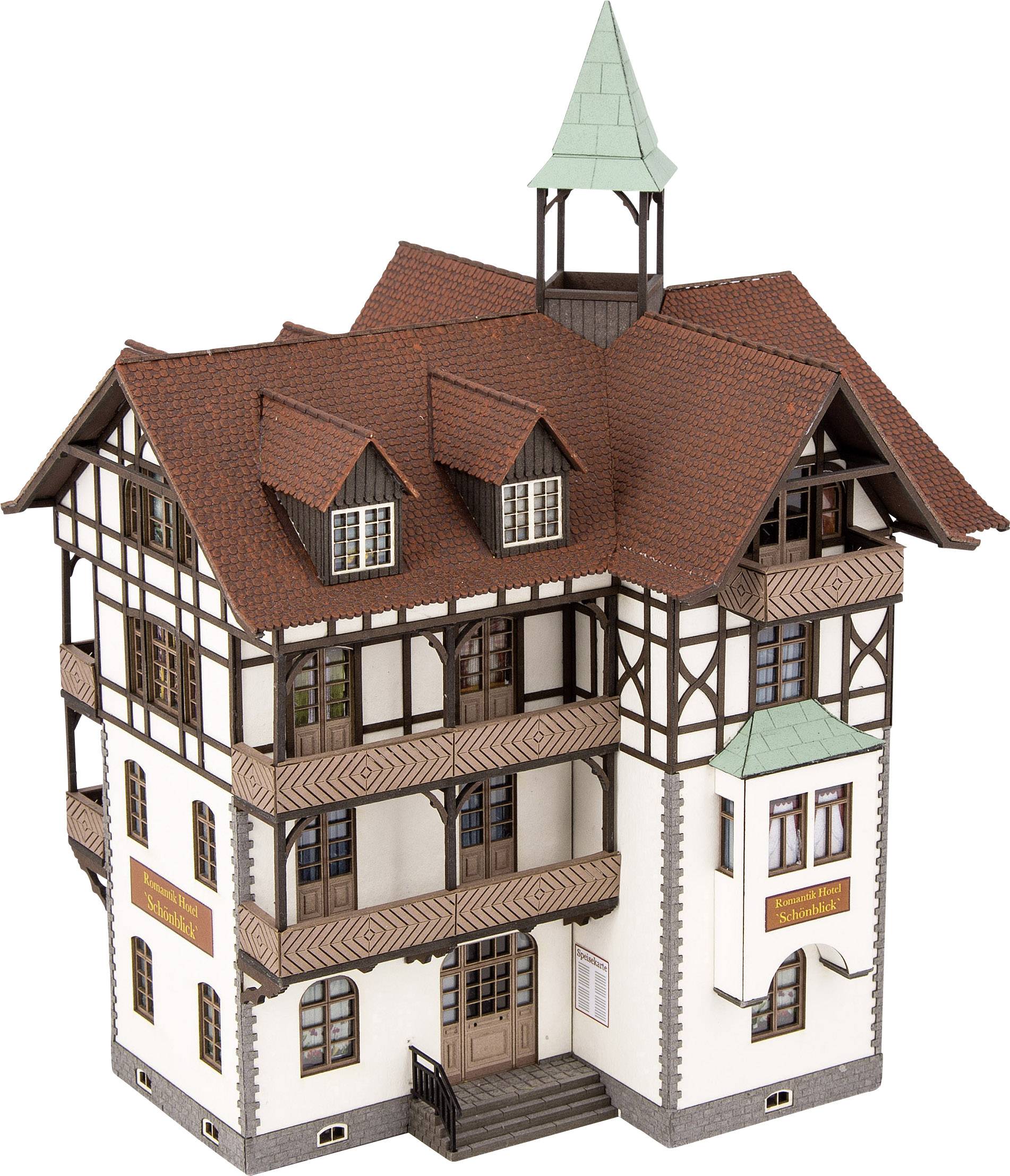 Traditional half-timbered house model with red roof tiles, multiple storeys, and a small tower, a typical example of German architecture.