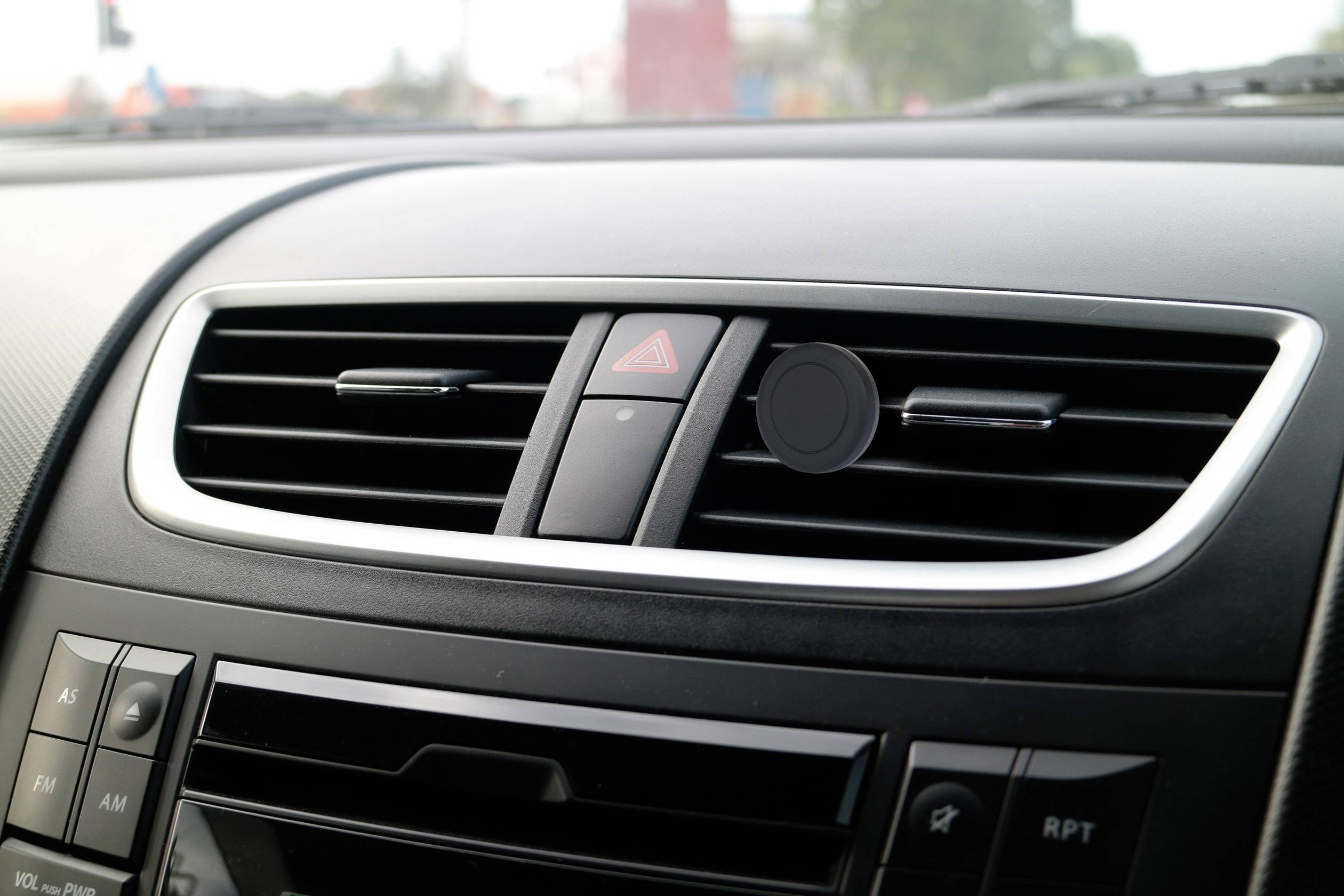 Car interior focusing on air vents and hazard warning light switch in the centre console.