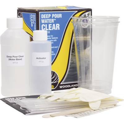 Plastic set consisting of two mixing bottles, a plastic cup, gloves, and wooden stirrers in front of packaging.