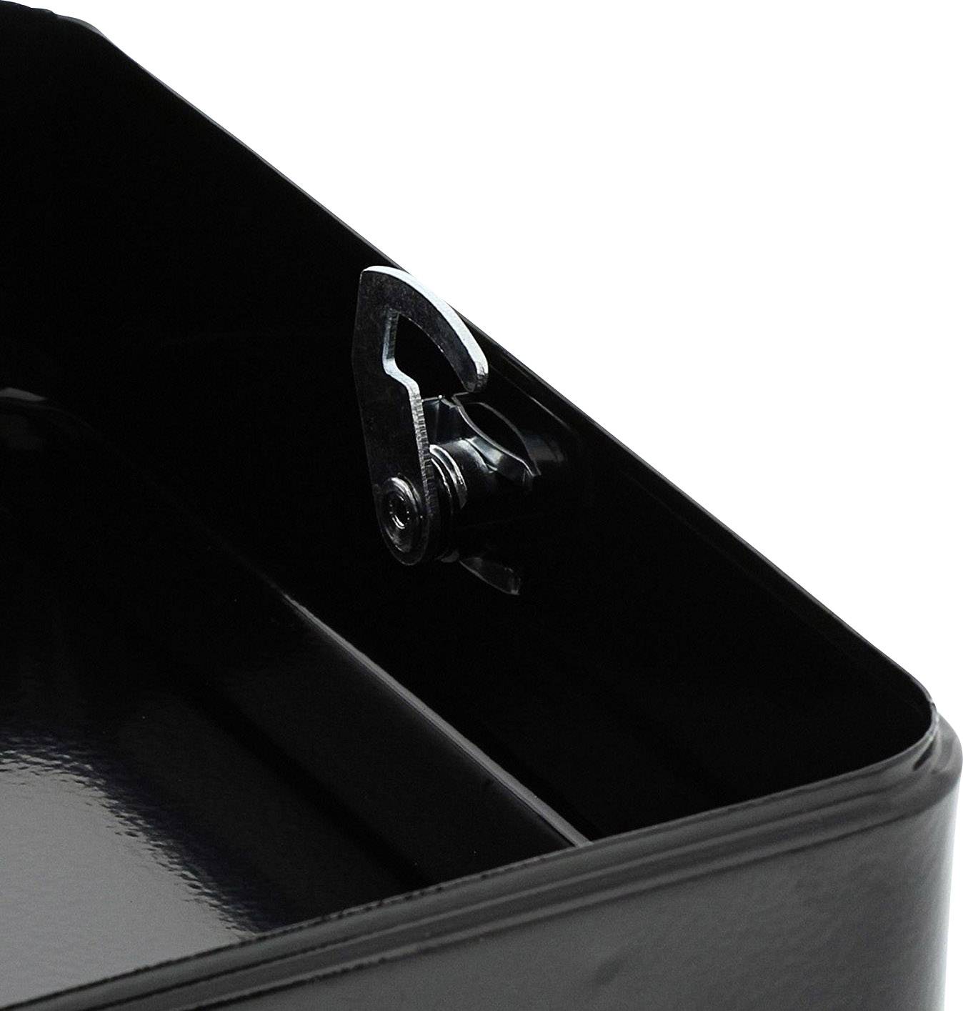 Black metal hinge at the corner of a box, showing construction detail.