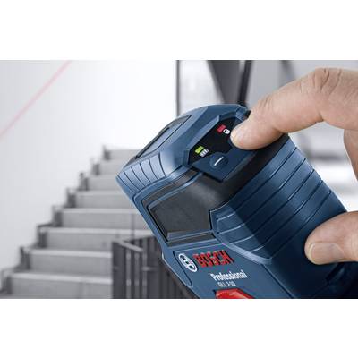 A hand holds a Bosch laser distance measurer, pointed at a staircase, with a visible display and laser line in the background.