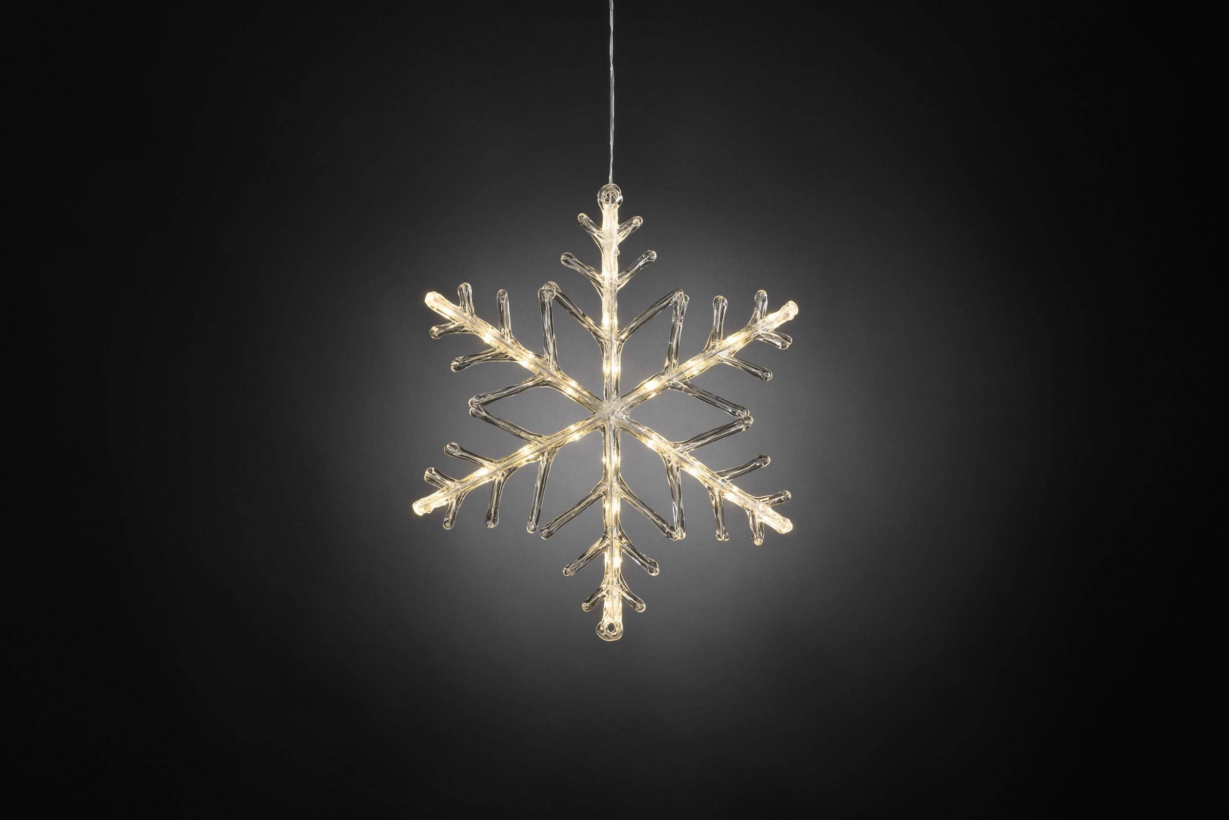 A luminous glass snowflake pendant, suspended against a dark background, illuminated and decorative.