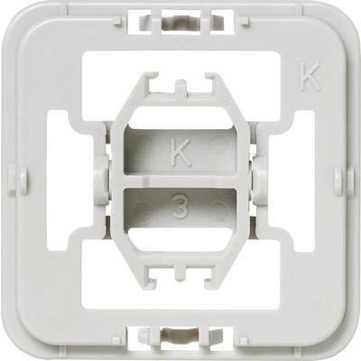 Grey square plastic component with four open areas and two 'K' markings.
