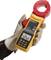 A hand wearing a glove is holding a yellow-orange clamp ammeter with a digital display; showing a measurement reading.