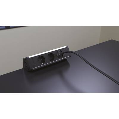 Power strip with two sockets sits on a black table, connected by a black cable.