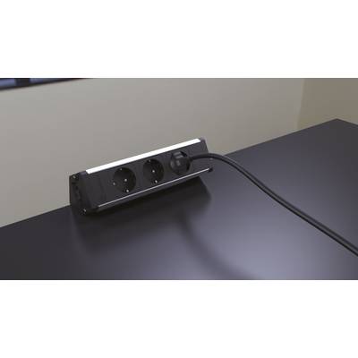 'A black cable is connected to a two-socket power strip on a table. The environment looks modern.'