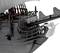 Large model of a historical sailing ship in black with white sails. A white angel figure is attached to the front.