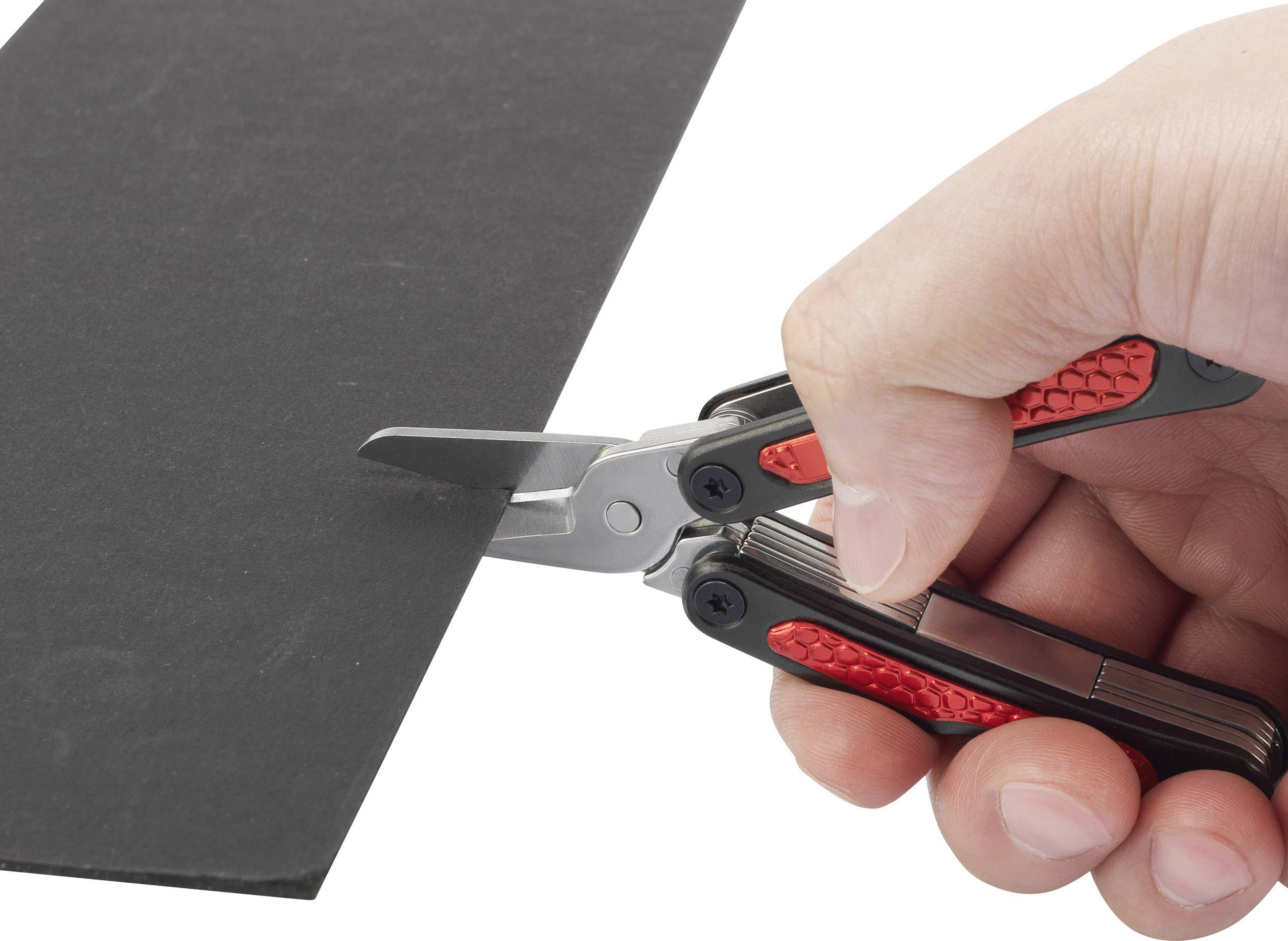 A hand is holding a multi-purpose scissors with a red handle and is cutting a piece of black material.