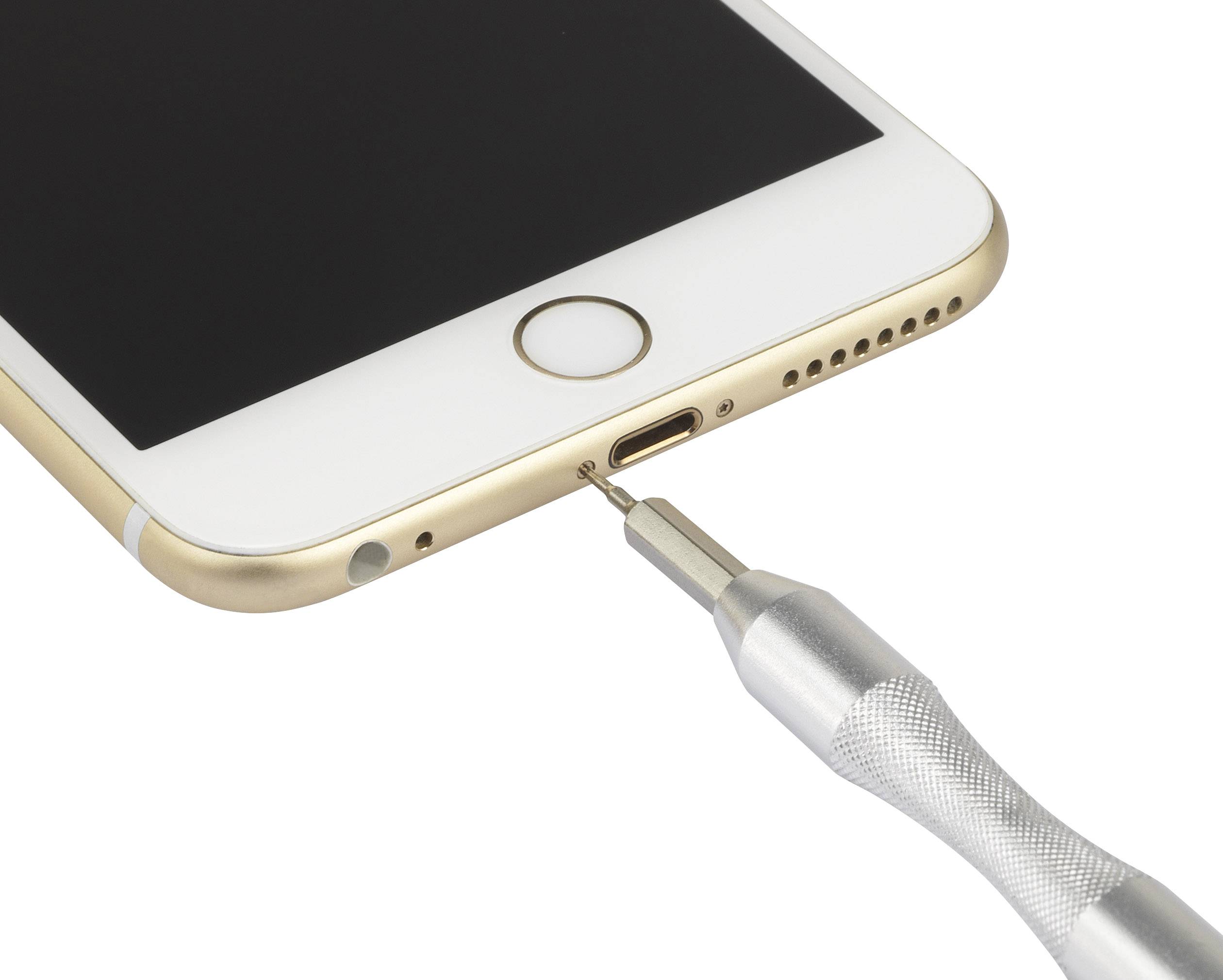 A screwdriver removes a screw near the charging port of a smartphone.