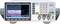 Function generator with digital display and controls showing sine wave, amplitude, and frequency. Left side multi-coloured screen, right side keypad and inputs.