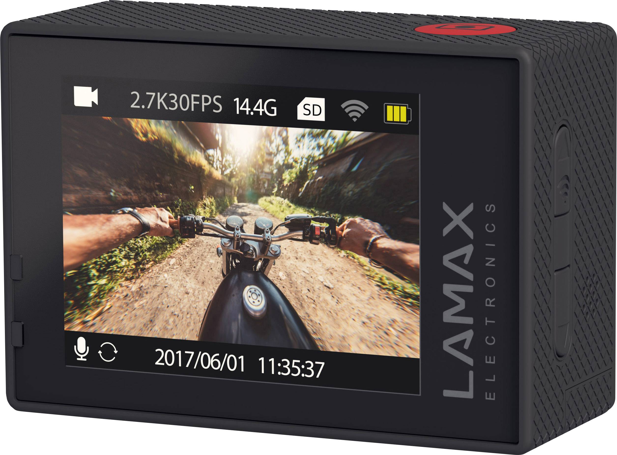 Rear view of an action camera with display; shows a recording of a motorcycle in motion on a gravel road from the rider's perspective.