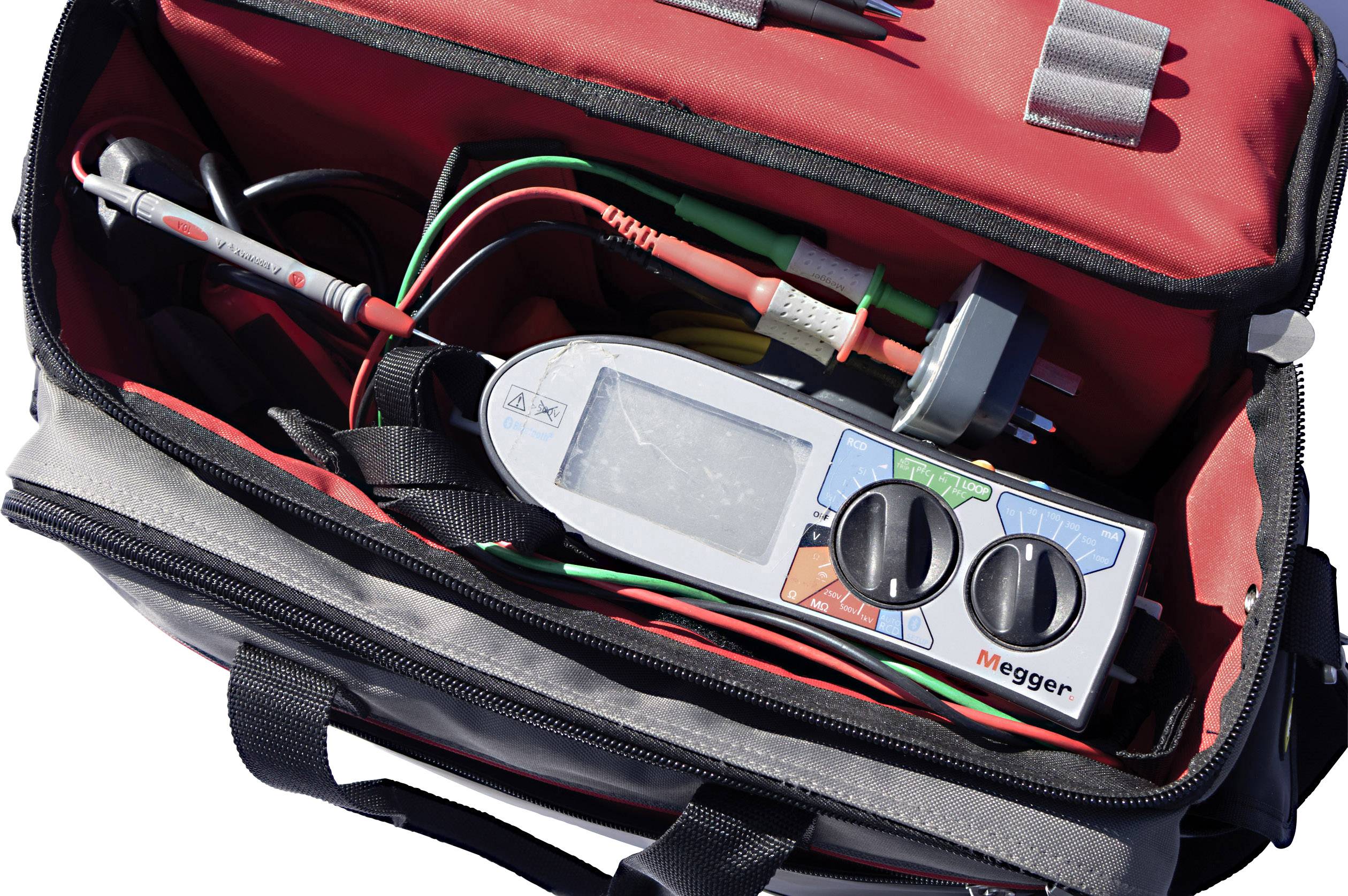 Opened tool bag with a digital measuring device and cables, ready for use.