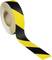A roll of safety adhesive tape with yellow and black stripes, typically used for warning purposes or cordoning off areas.