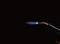 A burner generates a blue flame against a dark background, suggesting laboratory or welding work.