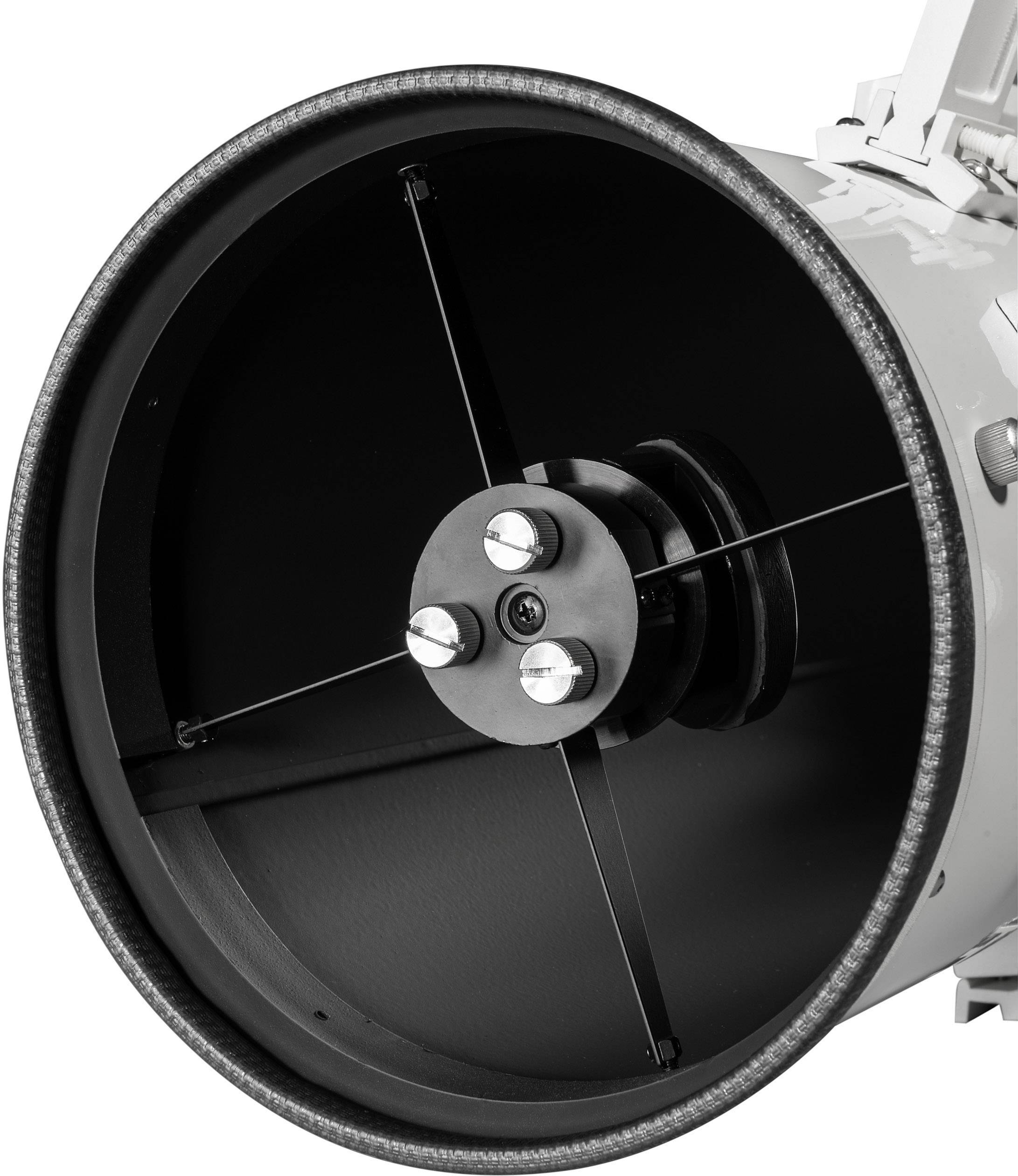 Black and white photograph of a telescope viewed from the front, with its internal mirror and mountings visible, focusing on technical details.
