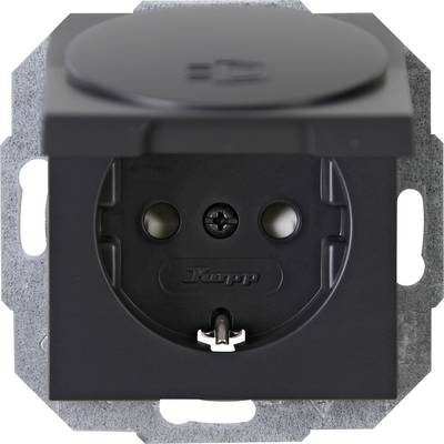 Black electrical socket in close-up, with hinged cover open. Socket has two holes and an earth connection. Brand name 'Kopp' visible.