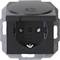 Black electrical socket in close-up, with hinged cover open. Socket has two holes and an earth connection. Brand name 'Kopp' visible.