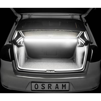A car with an open boot lid. The boot is brightly lit, with a net cover on top. The number plate reads 'OSRAM'.