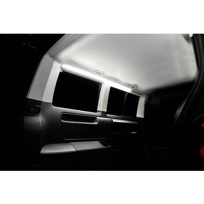 Rear view of the interior of a vehicle with subtle lighting and clean window lines, dark interior panelling, and modern design.