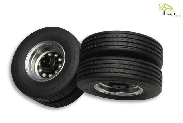 Two black rubber tyres with silver rims, standing upright and lying down, for model vehicles. Marking top right: 'thicon'.
