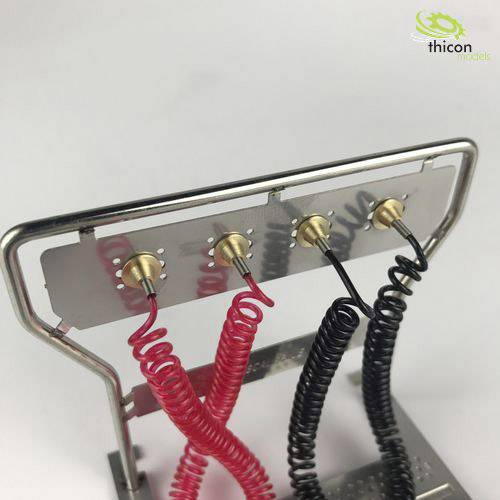 Metal frame with red and black wound wire springs attached to small buttons; brand logo top right.