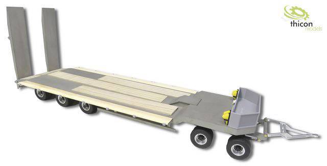 A scale model low-loader trailer with a detailed platform and movable ramps. A logo is located in the top right corner.