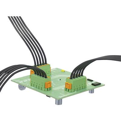 A green circuit board with several cables attached, plugged into orange-green connectors.