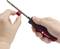 A hand holds a TOOLCRAFT screwdriver, while the other hand places a red and black cap onto the screwdriver.