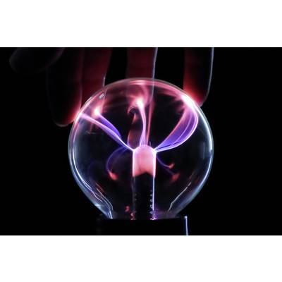 A hand touches a glowing plasma ball, from which colourful light rays emanate.